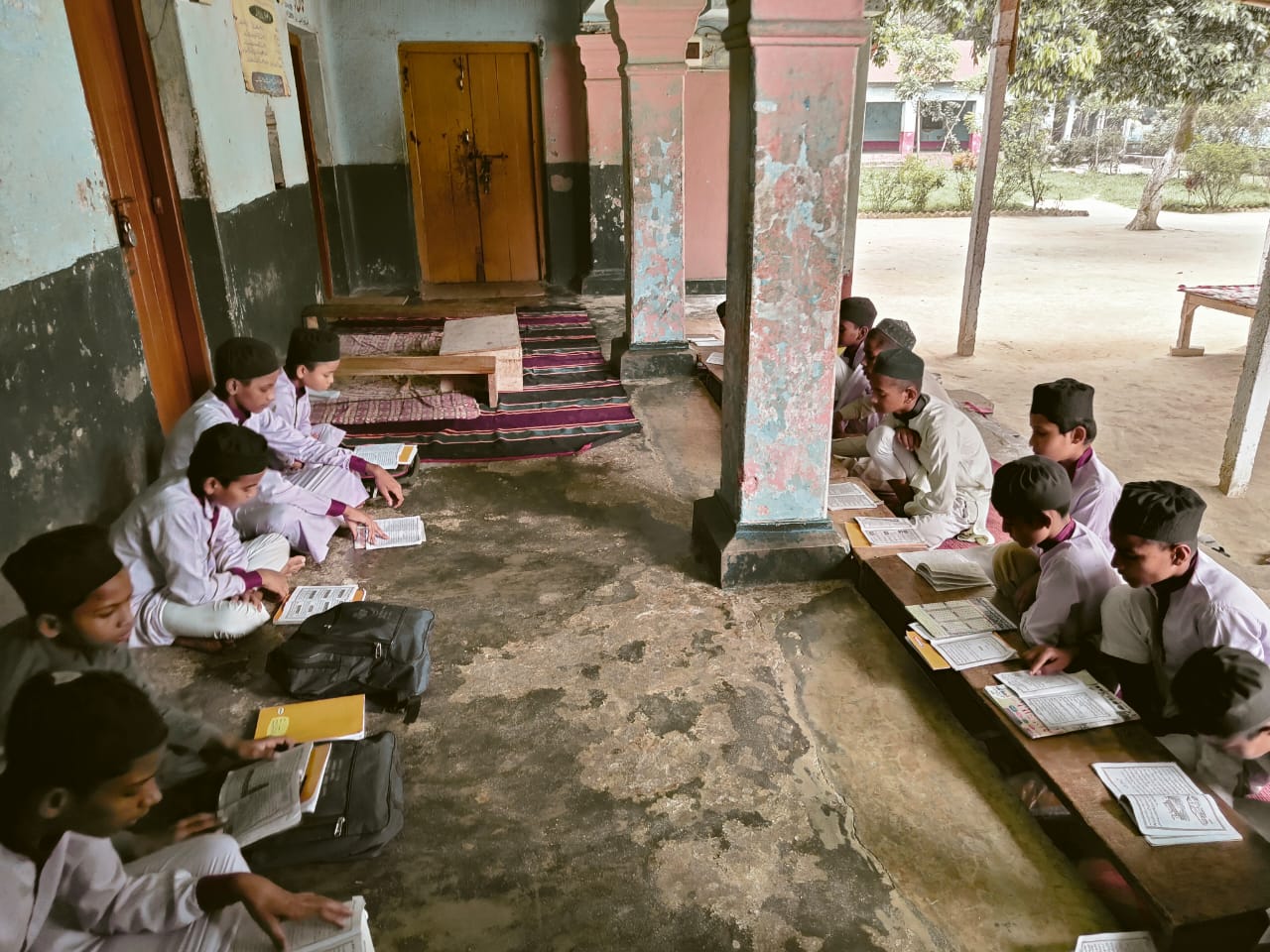 Interior of Jamia Usmania college library with students reading and shelves full of books